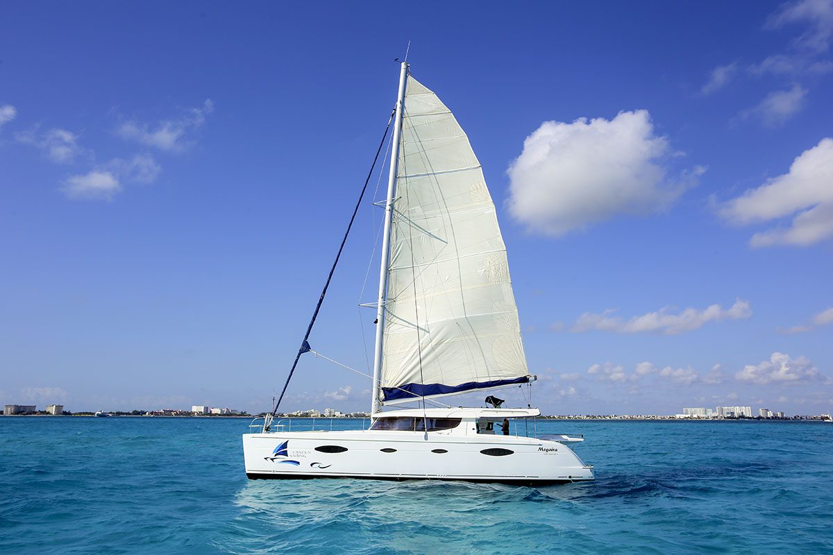 Sailing boat near Isla Mujeres with the sail up